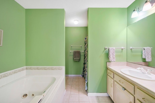 bathroom featuring tiled tub, vanity, and tile patterned floors