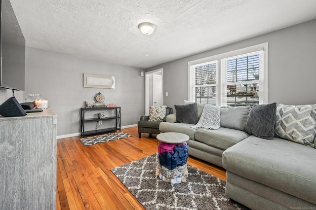 living room featuring hardwood / wood-style flooring and a textured ceiling