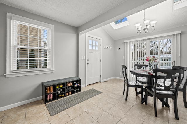 dining space featuring a textured ceiling, lofted ceiling, light tile patterned flooring, and a chandelier