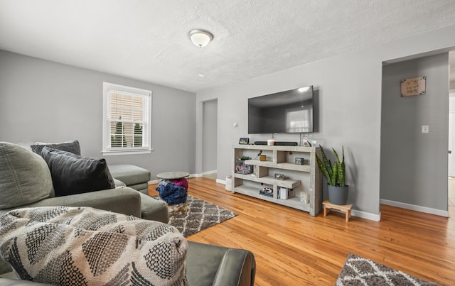 living room featuring a textured ceiling and hardwood / wood-style floors