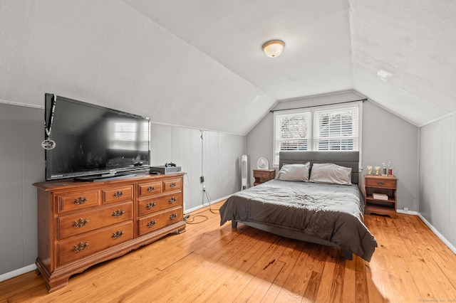 bedroom with lofted ceiling and hardwood / wood-style floors