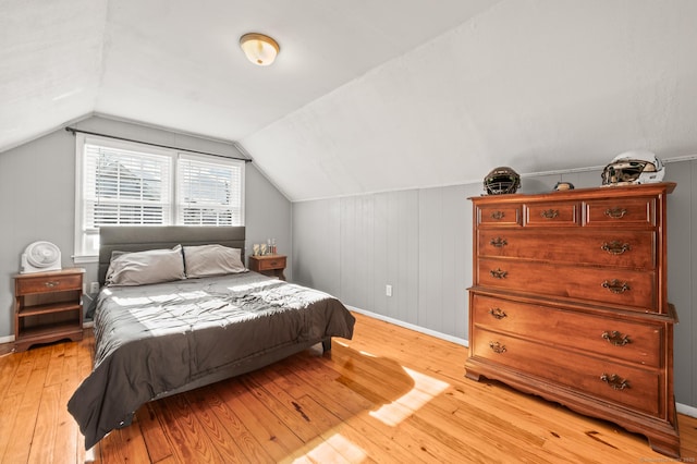 bedroom with light hardwood / wood-style flooring and vaulted ceiling