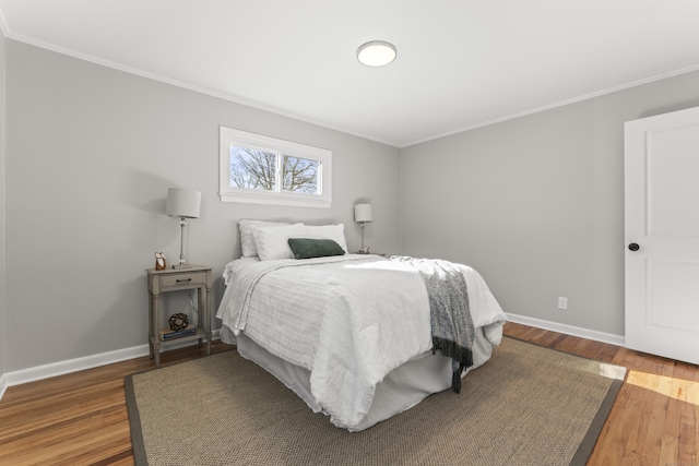 bedroom featuring hardwood / wood-style flooring and crown molding