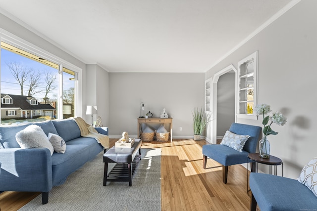 living room with hardwood / wood-style flooring and crown molding