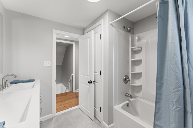 bathroom featuring sink, tile patterned floors, and shower / bath combo with shower curtain