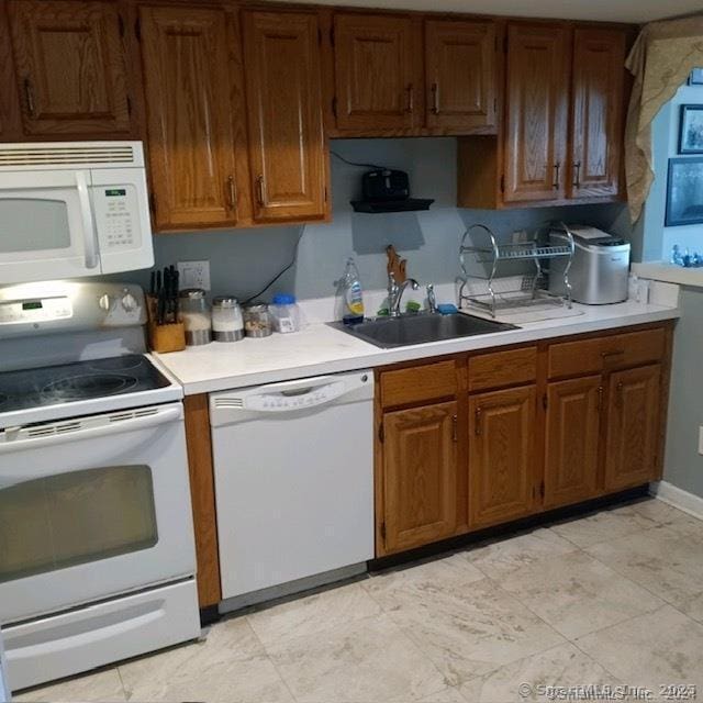 kitchen featuring sink and white appliances