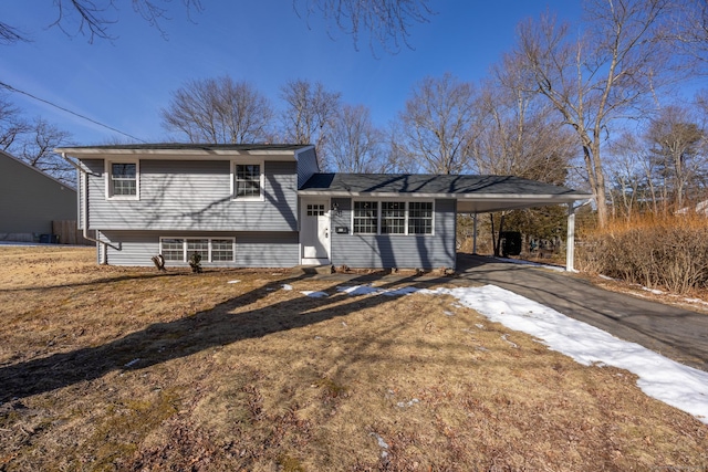 view of front of home with a carport and a front lawn