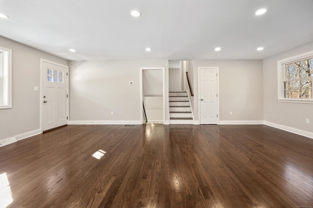 unfurnished living room with dark hardwood / wood-style floors