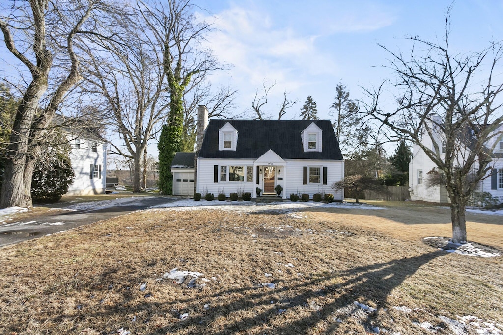 cape cod house with a garage