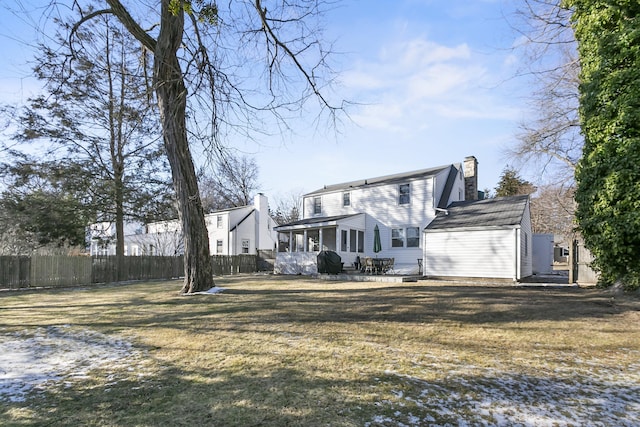 back of house with a lawn