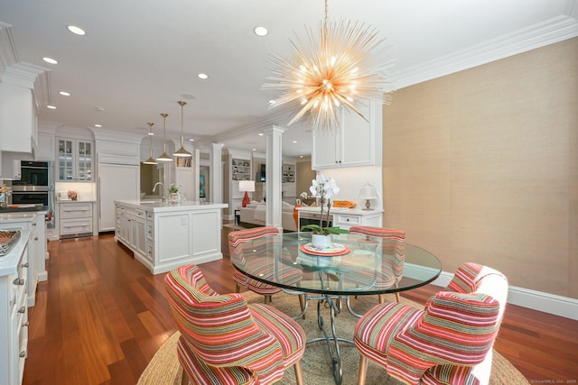 dining space with baseboards, an inviting chandelier, wood finished floors, and crown molding