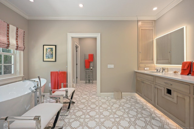 bathroom with vanity, baseboards, recessed lighting, a freestanding bath, and ornamental molding