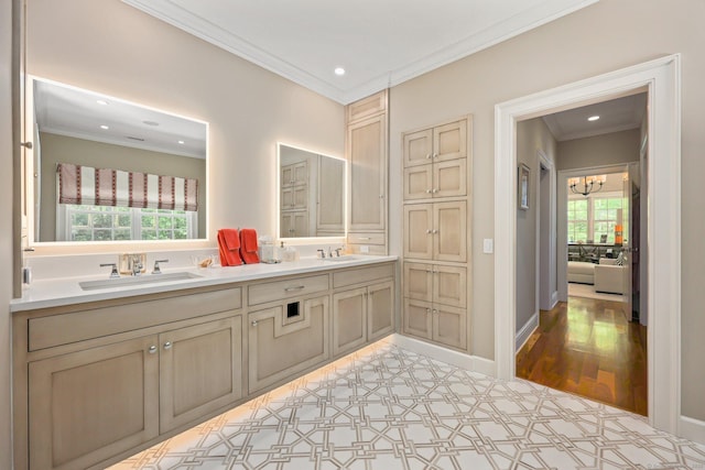 bathroom featuring a sink, an inviting chandelier, ornamental molding, and recessed lighting