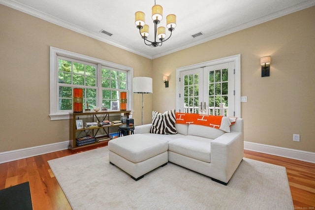 living area with a chandelier, visible vents, plenty of natural light, and french doors