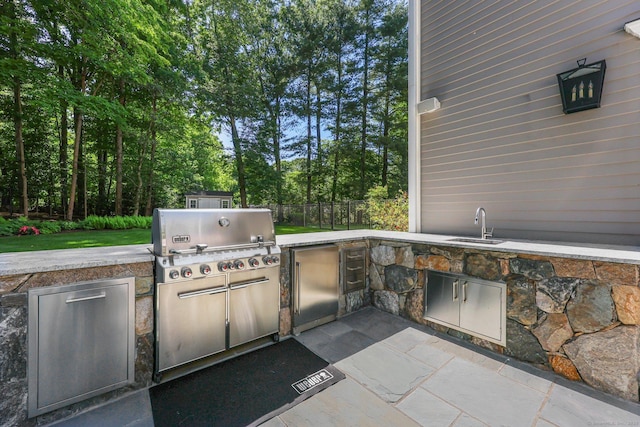 view of patio with grilling area, area for grilling, a sink, and fence