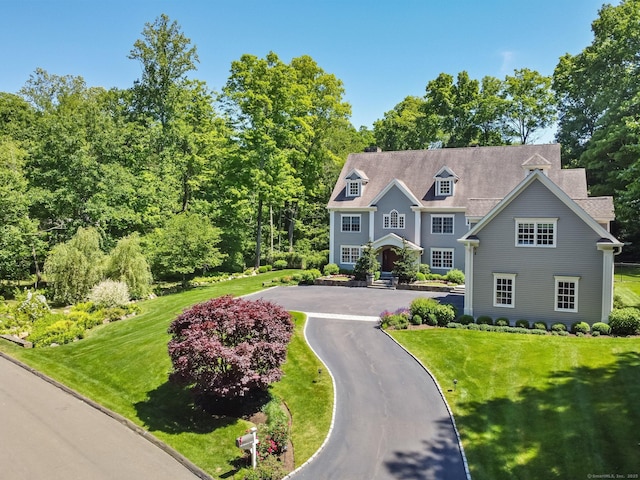 shingle-style home with a front lawn