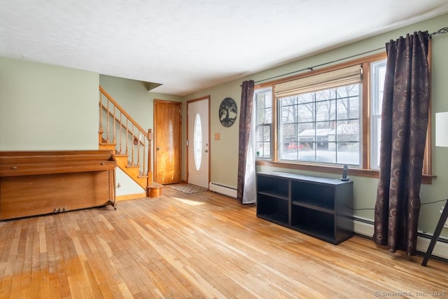 entryway with a baseboard heating unit and light hardwood / wood-style floors