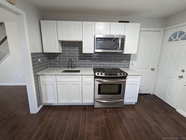 kitchen featuring stainless steel appliances, sink, and white cabinets