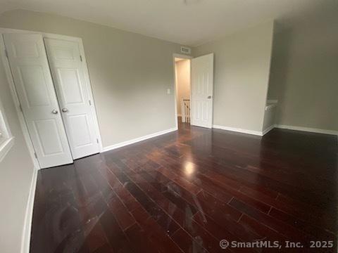 empty room featuring dark wood-type flooring