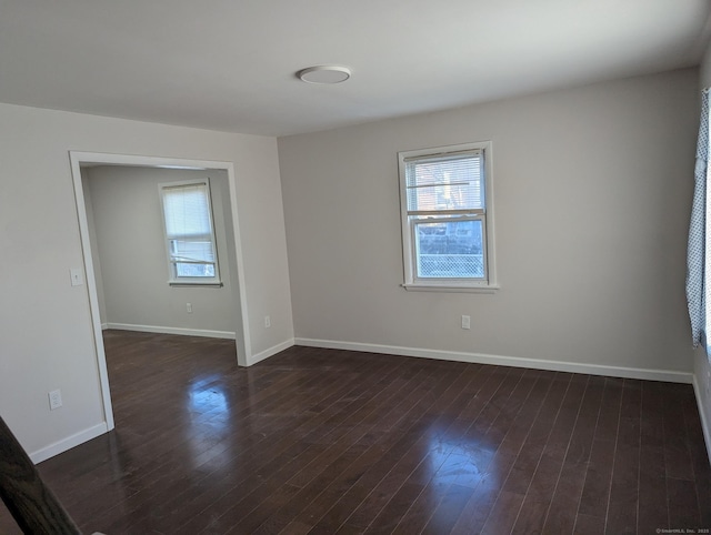 spare room featuring dark wood-type flooring