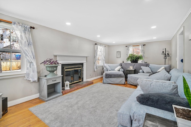 living room with ornamental molding and light hardwood / wood-style floors