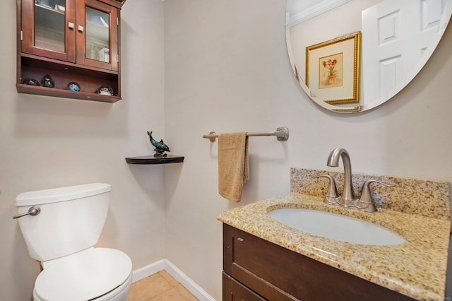 bathroom featuring vanity, tile patterned floors, and toilet