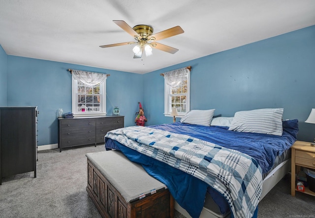 bedroom with multiple windows, light carpet, and ceiling fan