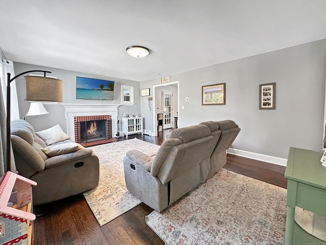 living room with a fireplace and dark hardwood / wood-style flooring