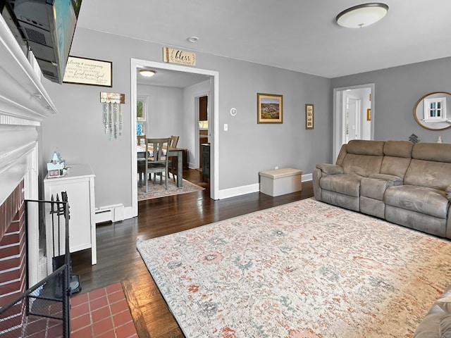 living room with dark hardwood / wood-style flooring and baseboard heating