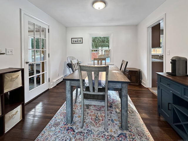 dining area featuring baseboard heating and dark hardwood / wood-style floors