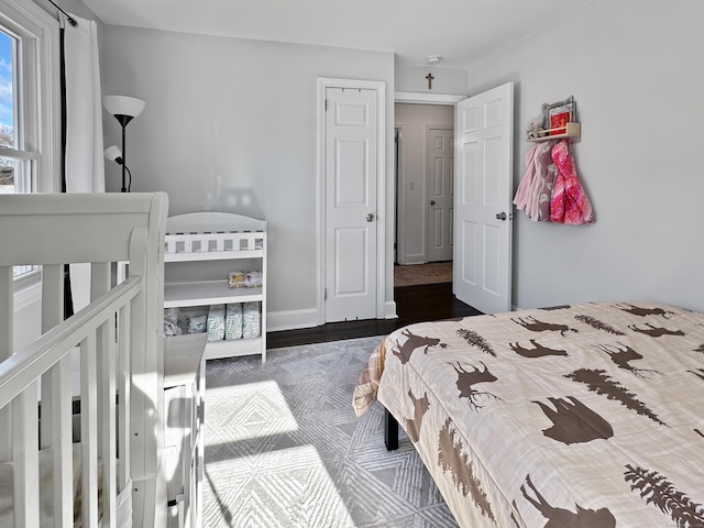 bedroom with dark hardwood / wood-style flooring