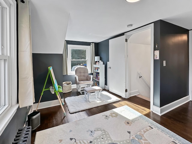 sitting room featuring dark wood-type flooring and radiator