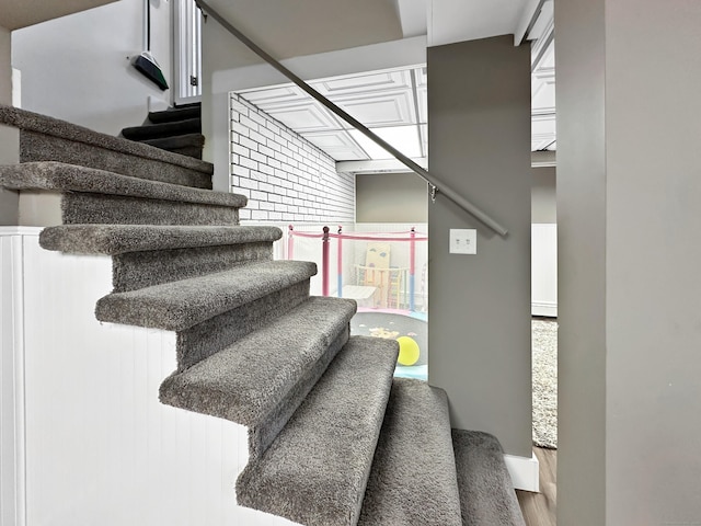 stairway with hardwood / wood-style flooring