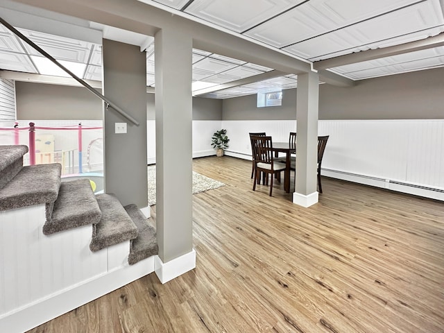 interior space with a baseboard radiator and hardwood / wood-style floors