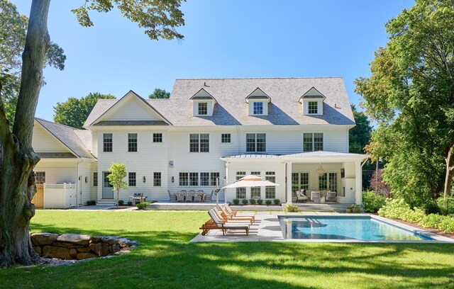 back of house with a patio, a yard, fence, and an outdoor pool