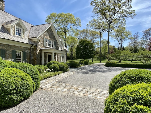 109 Elys Ferry Rd, Lyme, CT 06371 - view of home's exterior with a high end roof, stone siding, and a chimney