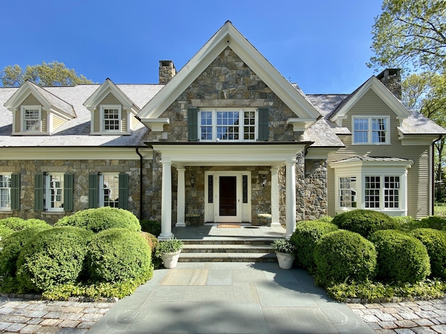 109 Elys Ferry Rd, Lyme, CT 06371 - view of front facade featuring a chimney, stone siding, and a porch