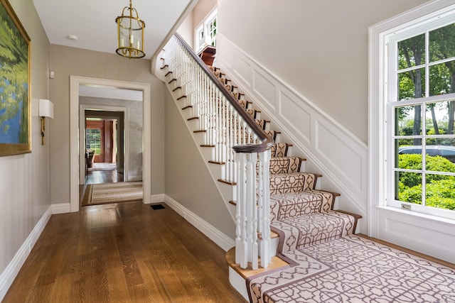 109 Elys Ferry Rd, Lyme, CT 06371 - entryway featuring dark wood finished floors, stairway, a chandelier, and a decorative wall