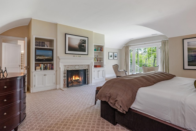 109 Elys Ferry Rd, Lyme, CT 06371 - bedroom with arched walkways, vaulted ceiling, a fireplace, and carpet floors