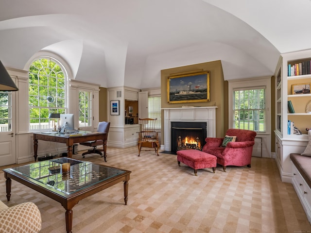109 Elys Ferry Rd, Lyme, CT 06371 - living room with vaulted ceiling, a desk, a fireplace with flush hearth, and light carpet