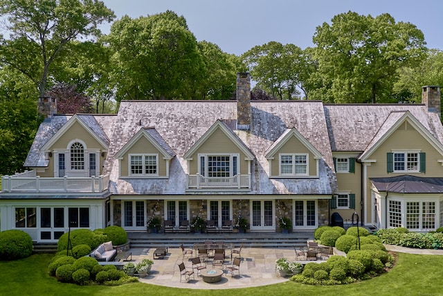 109 Elys Ferry Rd, Lyme, CT 06371 - back of house featuring a balcony, french doors, a chimney, and stone siding