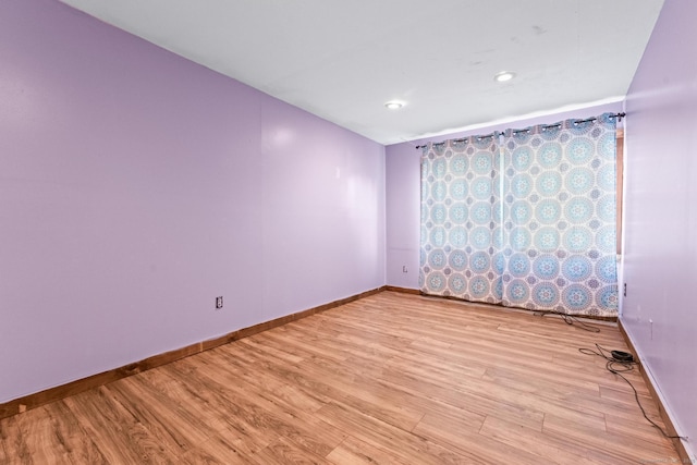 unfurnished room with light hardwood / wood-style flooring