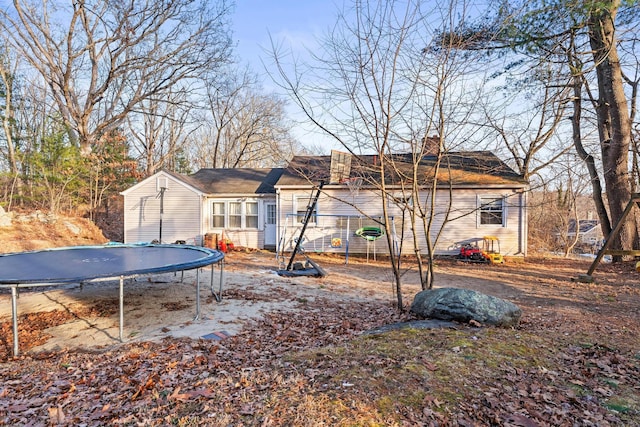 back of house featuring a trampoline