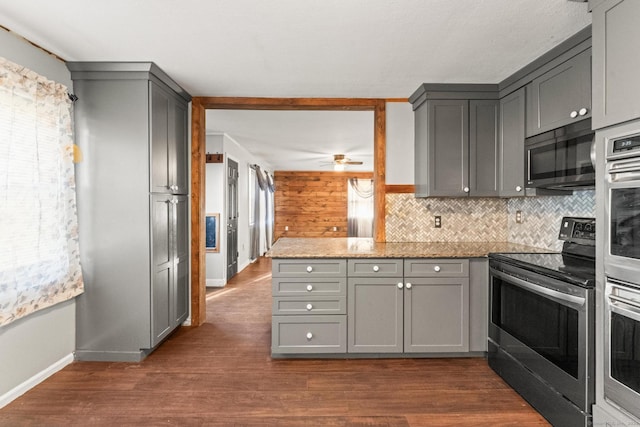 kitchen featuring gray cabinets, stainless steel range with electric cooktop, dark hardwood / wood-style floors, and stone counters