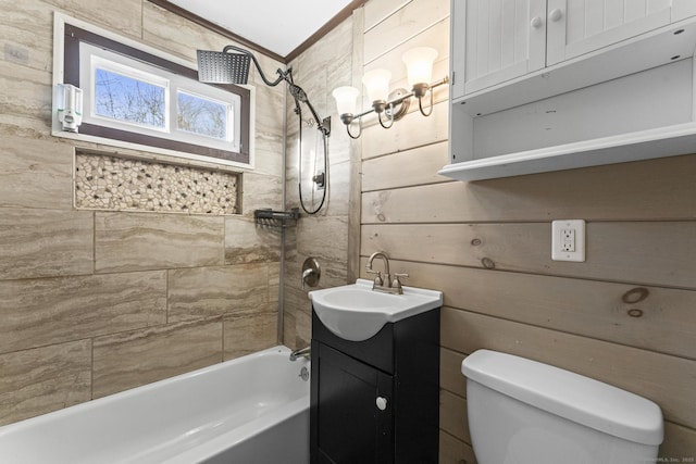 full bathroom with vanity, tiled shower / bath combo, crown molding, and toilet