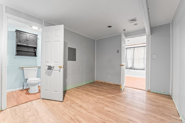 interior space featuring crown molding, wood-type flooring, and electric panel