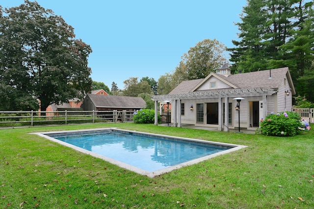 view of pool featuring fence, a lawn, and a pergola