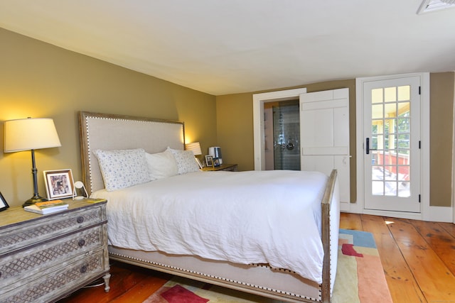 bedroom featuring visible vents and hardwood / wood-style floors