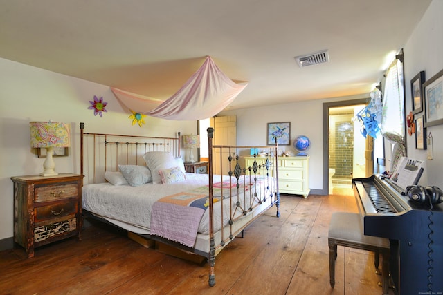 bedroom with hardwood / wood-style floors and visible vents