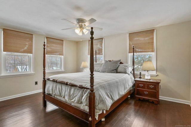 bedroom with dark hardwood / wood-style flooring and ceiling fan